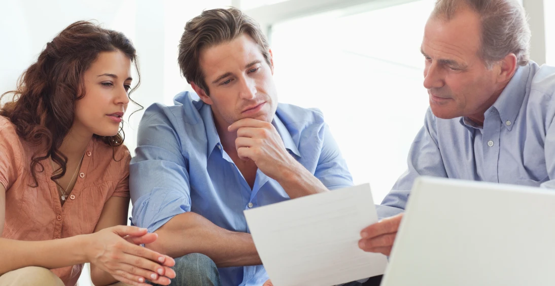 Couple reviewing documents with an advisor.